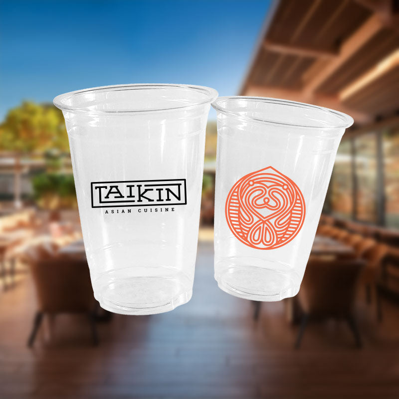 Two clear cold cups custom-printed with restaurant logos